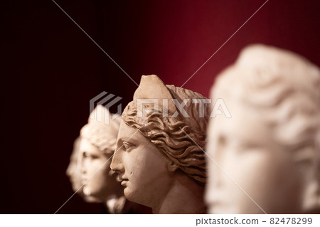 closeup of woman antique statues on red background closeup of woman antique statues on red background 82478299