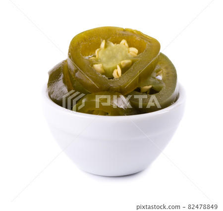 Pickled jalapeno pepper in ceramic bowl, isolated on white background. Slices of preserved hot serrano. 82478849