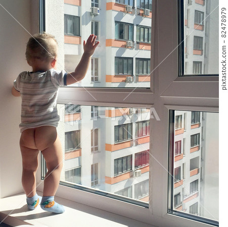 Beautiful baby boy with child face posing photographer near window 82478979