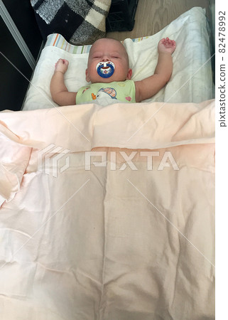 Sleeping baby boy with child pacifier posing photographer for color photo Sleeping baby boy with child pacifier posing photographer for color photo 82478992