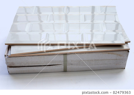 Stack of tiles on white background. 82479363