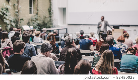 Man giving presentation in lecture hall at university. Man giving presentation in lecture hall at university. 82480022