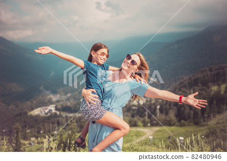 Mother hugging daughter. Holiday trip concept Mother hugging daughter. Holiday trip concept 82480946