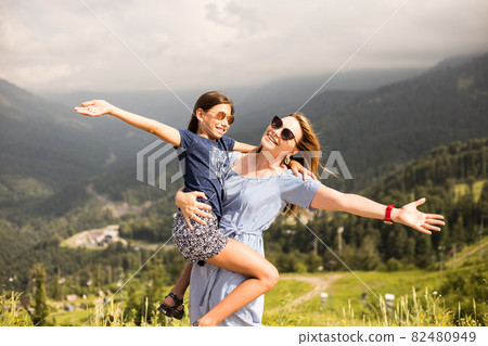 Mother hugging daughter. Holiday trip concept Mother hugging daughter. Holiday trip concept 82480949