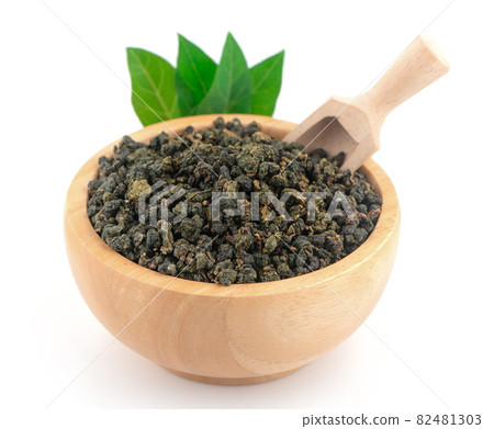 Heap of dried green tea isolated on white background 82481303