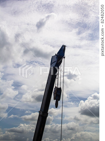 Hydraulic crane beams against blue sky 82482050