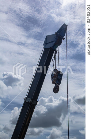 Hydraulic crane beams against blue sky 82482051