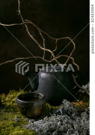 Craft handmade ceramic teapot on moss as background Craft handmade ceramic teapot on moss as background 82483004