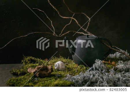 Craft handmade ceramic teapot on moss as background 82483005