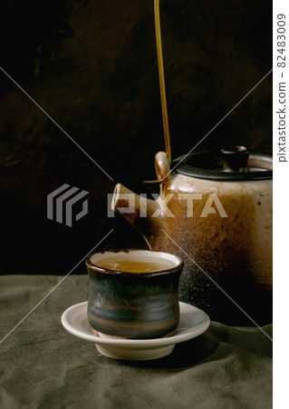 Craft handmade ceramic teapots with dark background Craft handmade ceramic teapots with dark background 82483009