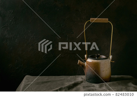 Craft handmade ceramic teapot with dark background Craft handmade ceramic teapot with dark background 82483010
