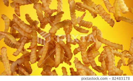 Freeze motion of flying french fries on golden background 82483178