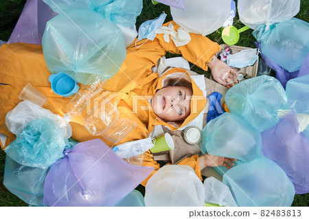 Woman suffering of hoarding abnormal disorder at her planet and laying around the rubbish Woman suffering of hoarding abnormal disorder at her planet and laying around the rubbish 82483813