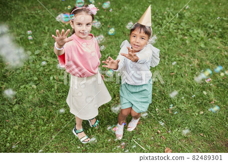 Girls Catching Bubbles Girls Catching Bubbles 82489301