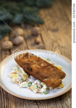 Traditional Christmas dinner in Czech Republic - carp fillet with potato salad Traditional Christmas dinner in Czech Republic - carp fillet with potato salad 82490598