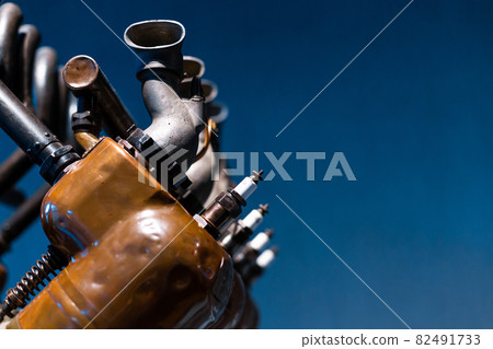 Close-up of a detail of a rare car engine. Metal mechanisms. Automotive industry Close-up of a detail of a rare car engine. Metal mechanisms. Automotive industry 82491733