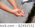 Hands of a child washing hands with a tap 82492532