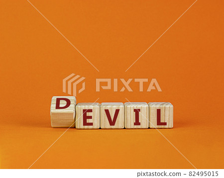Devil is evil symbol. Turned a cube with words 'Devil is evil'. Beautiful orange background. Religion and God is good concept. Devil is evil symbol. Turned a cube with words 'Devil is evil'. Beautiful orange background. Religion and God is good concept. 82495015