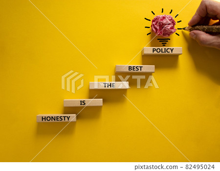Business concept growth success process. Wood blocks stacking as step stair on yellow background, copy space. Businessman hand. Words 'honesty is the best policy'. Conceptual image of motivation. Business concept growth success process. Wood blocks stacking as step stair on yellow background, copy space. Businessman hand. Words 'honesty is the best policy'. Conceptual image of motivation. 82495024