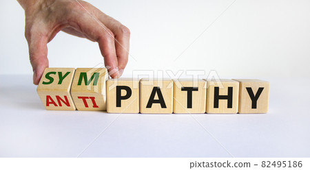 From antipathy to sympathy. Businessman turns cubes and changes the word 'antipathy' to 'sympathy'. Beautiful white background. Copy space. Psychological and antipathy or sympathy concept. 82495186