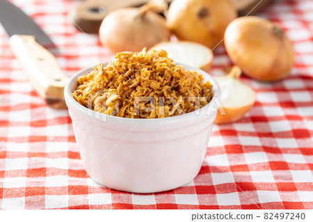 Pieces of fried onions in bowl. Pieces of fried onions in bowl. 82497240