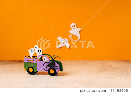 Happy halloween holiday concept. Halloween handmade paper decorations, spiders, ghosts in car, bats, boo text on orange background. Halloween festival party, greeting card mockup with copy space 82498206