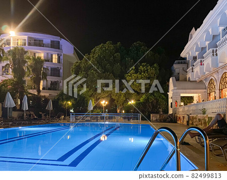 A beautiful chic getaway hotel in a tropical southern resort with a swimming pool at night A beautiful chic getaway hotel in a tropical southern resort with a swimming pool at night 82499813
