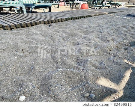 Wooden boardwalk at a sandy beach Wooden boardwalk at a sandy beach 82499815