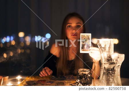 Woman reading tarot cards in spiritual room. 82500738