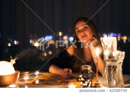 Woman reading tarot cards in spiritual room. 82500739