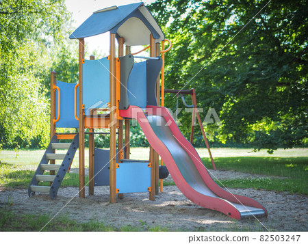 Colorful playground slide with the trees at the background 82503247