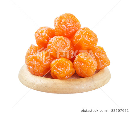 Dried prunes fruits (Preserved fruits Chinese plum) in wooden bowl. Dried prunes fruits (Preserved fruits Chinese plum) in wooden bowl. 82507651