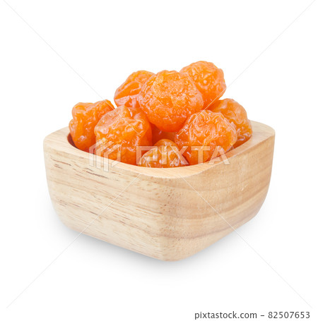Dried prunes fruits (Preserved fruits Chinese plum) in wooden bowl. Dried prunes fruits (Preserved fruits Chinese plum) in wooden bowl. 82507653
