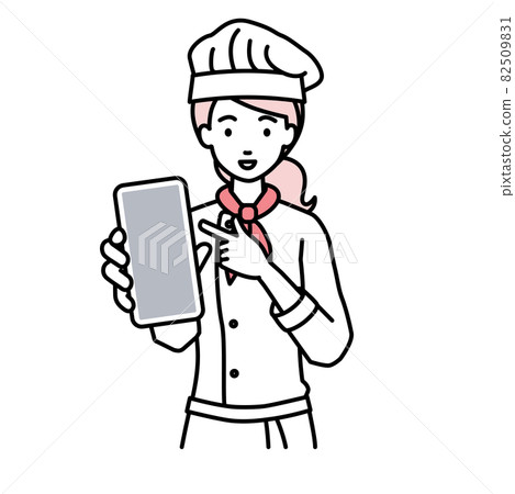 一個廚師女人站著指著她的智能手機 一個廚師女人站著指著她的智能手機 82509831
