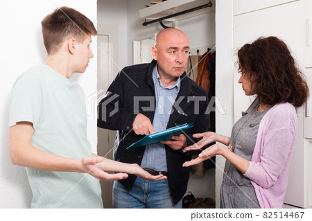 Debt collector and worried woman and teenage son 82514467
