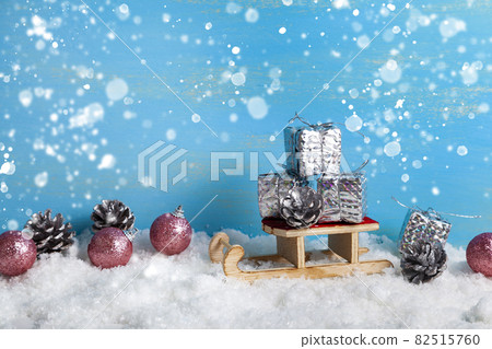Sleds and New Year's gifts in the snow. Christmas decor. 82515760