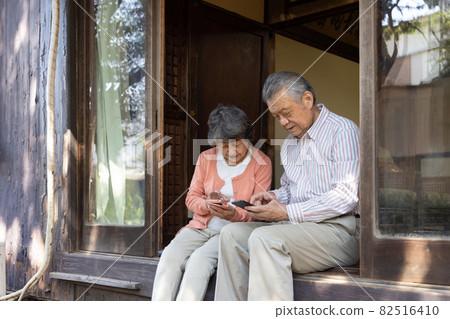 Near couple using a smartphone 82516410