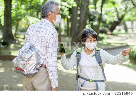 A senior couple heading to a designated evacuation facility A senior couple heading to a designated evacuation facility 82516946