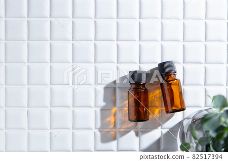 Two bottles of aroma oil and eucalyptus leaves. There is copy space. 82517394