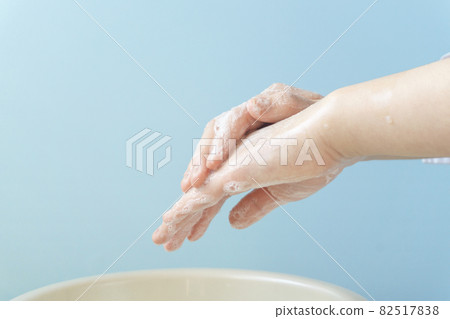 A child who washes his hands with soap. Girl's hand close-up. 82517838