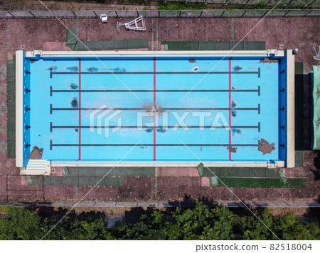 An abandoned pool with drained water as seen from above An abandoned pool with drained water as seen from above 82518004