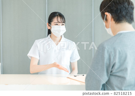 Nurses and patients (masks) at the reception Nurses and patients (masks) at the reception 82518215
