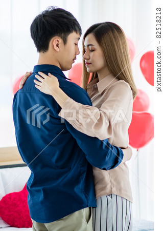 Asian couple dancing during date 82518218