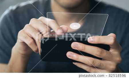 Man using smartphone for watching video on internet, online streaming, online class, content creator 82518596