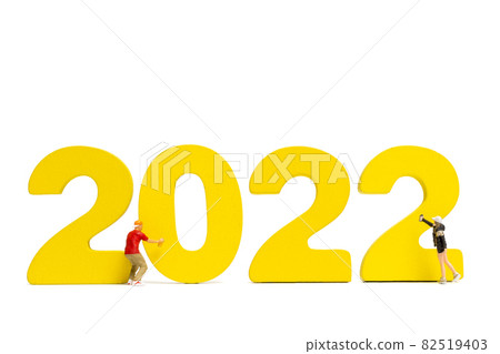 Miniature people Teenager spraying paint Number 2022 on white background 82519403