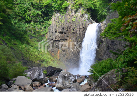 Naena Waterfall that daringly flows down the rock wall of columnar joints of basalt Naena Waterfall that daringly flows down the rock wall of columnar joints of basalt 82520536