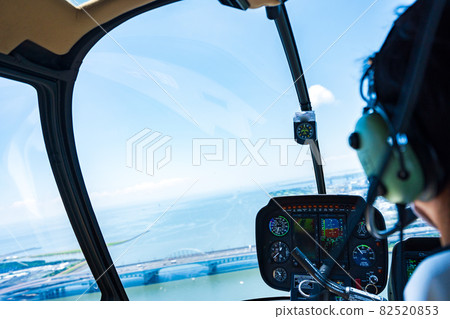 Pilot operating a helicopter Pilot operating a helicopter 82520853