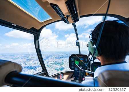 Pilot operating a helicopter Pilot operating a helicopter 82520857
