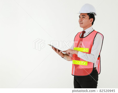 An asian architectural engineer in white shirt red tie wearing white safety hard hat holding a clipboard with documents to checking the project, standing on white background. 82520945