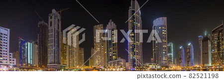View of the skyscrapers of Dubai Marina district at night 82521198